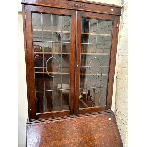 422 - 1920’s oak bureau bookcase on barleytwist legs, leaded glass to doors