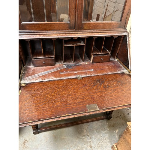 422 - 1920’s oak bureau bookcase on barleytwist legs, leaded glass to doors