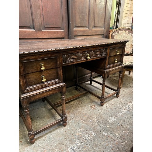 505 - 1920's oak desk with turned legs, 5 drawers and heavy brass drop handles