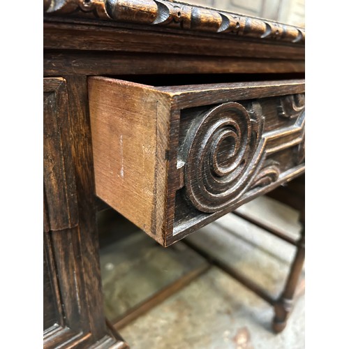 505 - 1920's oak desk with turned legs, 5 drawers and heavy brass drop handles