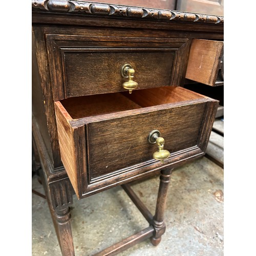 505 - 1920's oak desk with turned legs, 5 drawers and heavy brass drop handles