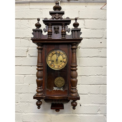 271 - A Victorian Vienna style wall clock, the face with roman numerals. With pendulum & key. Needs attent... 