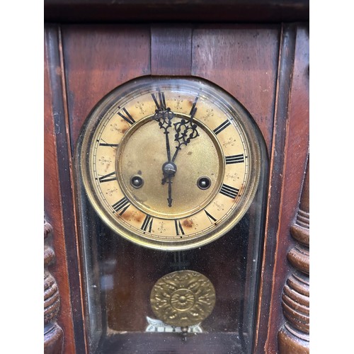 271 - A Victorian Vienna style wall clock, the face with roman numerals. With pendulum & key. Needs attent... 