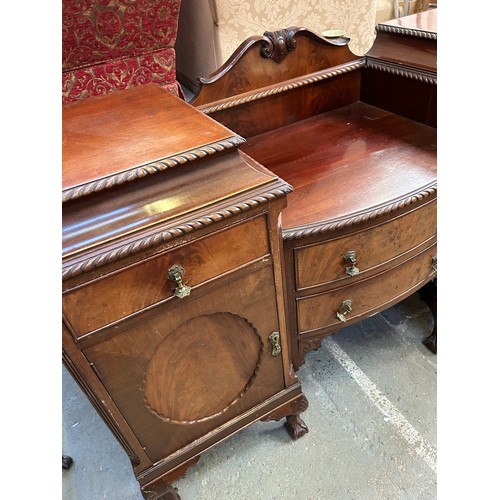 468 - A large 1920's Mahogany Sideboard with two central bow fronted drawers flanked by cupboards on cabri... 