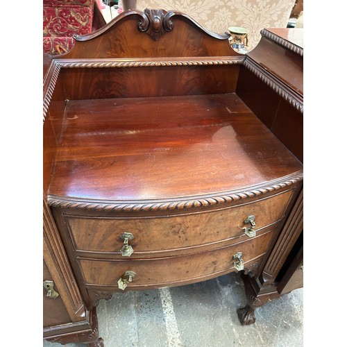 468 - A large 1920's Mahogany Sideboard with two central bow fronted drawers flanked by cupboards on cabri... 