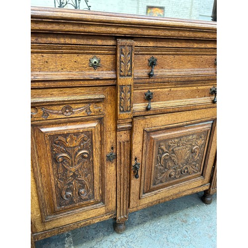 465 - Large Victorian Oak sideboard with mirrored top. The front door panels heavily carved in the Classic... 