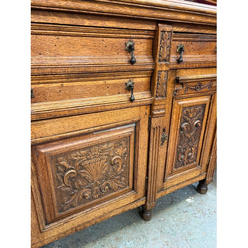 465 - Large Victorian Oak sideboard with mirrored top. The front door panels heavily carved in the Classic... 