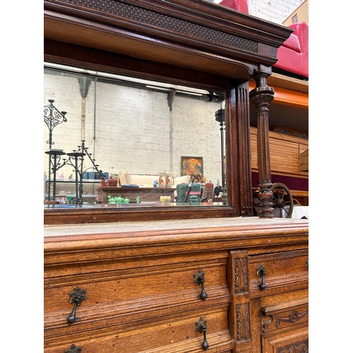 465 - Large Victorian Oak sideboard with mirrored top. The front door panels heavily carved in the Classic... 