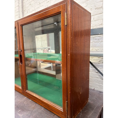 495 - Mid Century teak wall cupboard with glazed doors, baize lined shelves. Marked W & D 1951 and a 