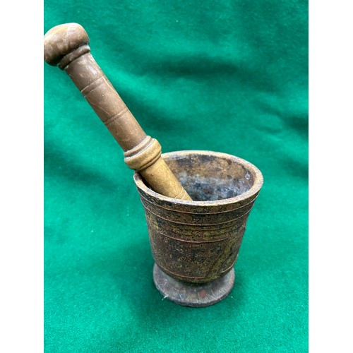 431 - Antique cast brass mortar and pestle with unusual raised design on the mortar