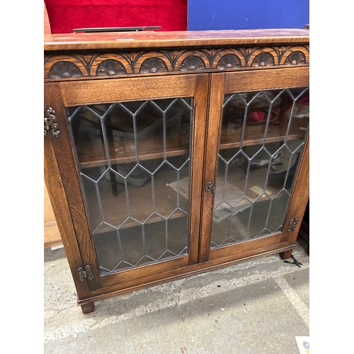 459 - Old Charm style oak leaded glass fronted display cabinet with carved frieze & two internal shelves. ... 