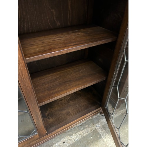 459 - Old Charm style oak leaded glass fronted display cabinet with carved frieze & two internal shelves. ... 