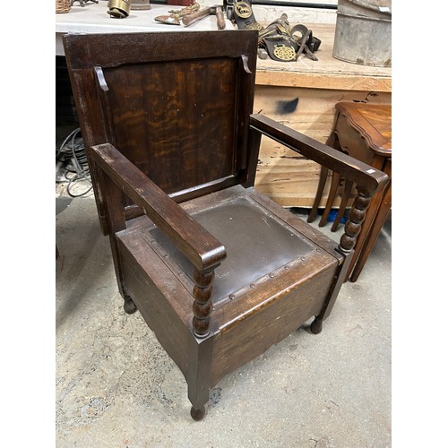 458 - 1920's oak metamorphic commode side table. The chair back lifts and is hinged to form the table top.... 