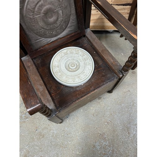 458 - 1920's oak metamorphic commode side table. The chair back lifts and is hinged to form the table top.... 