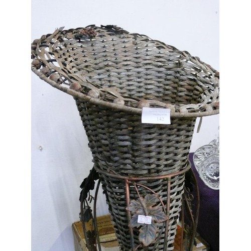 125 - A LARGE WICKER VASE WITH WROUGHT IRON STAND