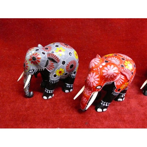 77 - 3 EBONISED ELEPHANT FIGURES AND 2 BATIK WOODEN ELEPHANTS