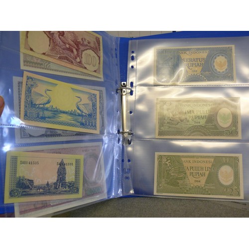 54 - A FOLDER OF 14 INDONESIAN BANK NOTES