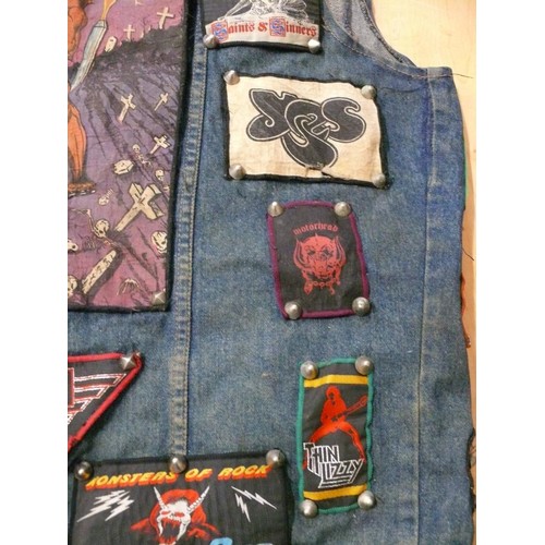 140 - DENIM WAIST COAT ADORNED IN HEAVY METAL BADGES BOTH METAL AND FABRIC