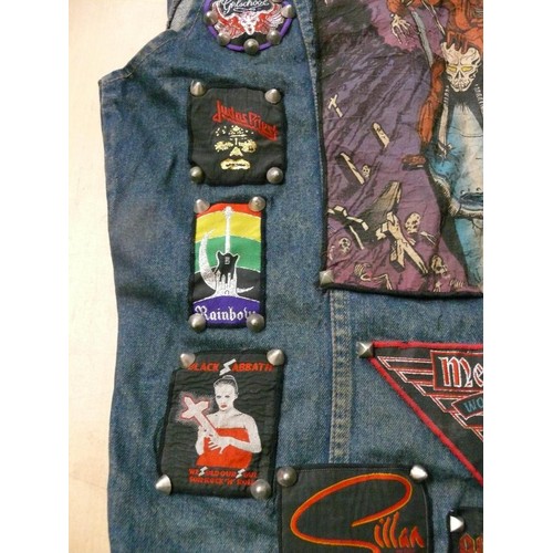 140 - DENIM WAIST COAT ADORNED IN HEAVY METAL BADGES BOTH METAL AND FABRIC