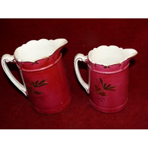 257 - 2 VINTAGE JUGS WITH SCALLOPED EDGING IN CERISE AND GILT