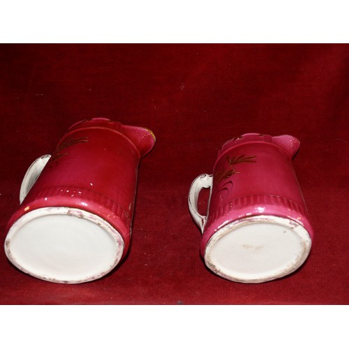 257 - 2 VINTAGE JUGS WITH SCALLOPED EDGING IN CERISE AND GILT