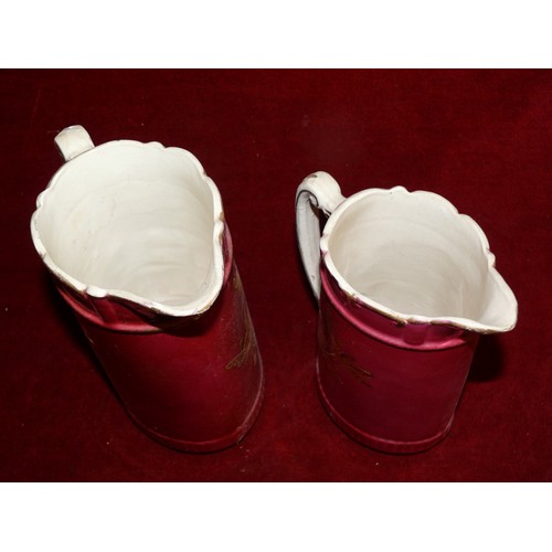 257 - 2 VINTAGE JUGS WITH SCALLOPED EDGING IN CERISE AND GILT