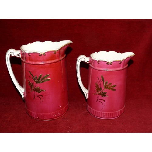 257 - 2 VINTAGE JUGS WITH SCALLOPED EDGING IN CERISE AND GILT