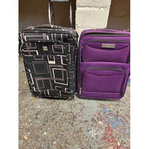 187 - TWO SMALL SUITCASES ON WHEELS, PURPLE ONE BY SOVEREIGN AND BLACK AND BEIGE DESIGN BY SKYFKLITE LONDO... 