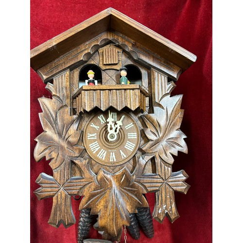 143 - A VINTAGE BLACK FOREST WOODEN CUCKOO CLOCK WITH PINE CONE WEIGHTS & PENDULUM