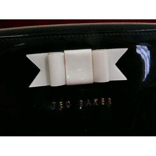 383 - TED BAKER TABLET CASE IN BLACK PATENT WITH CREAM BOW.