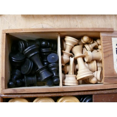 384 - VINTAGE DRAUGHTS AND CHESS PIECES IN WOODEN 'SLIDE-LID' BOXES.