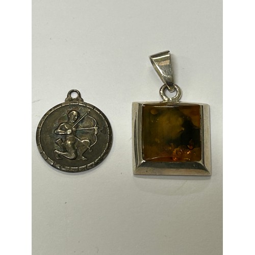 28 - AN AMBER AND SILVER PENDANT AND A Sagittarius SILVER PENDANT