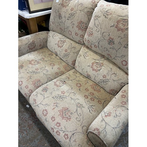 473 - 2-SEATER DRALON SOFA. CREAM FLORAL.