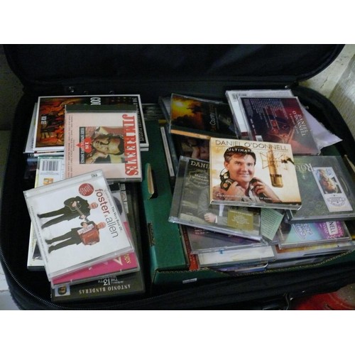 437 - QUANTITY OF MUSIC CD'S AND FILM DVDS CONTAINED IN A LARGE SUITCASE.