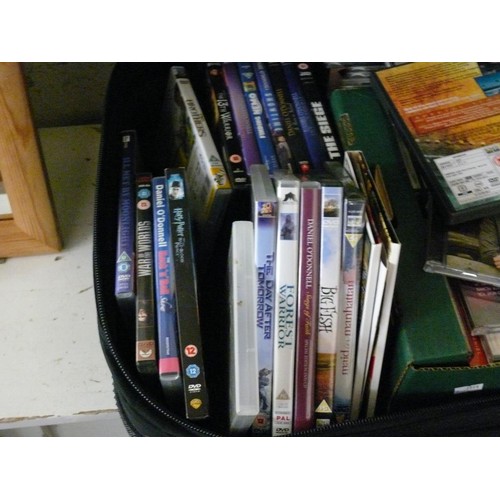 437 - QUANTITY OF MUSIC CD'S AND FILM DVDS CONTAINED IN A LARGE SUITCASE.