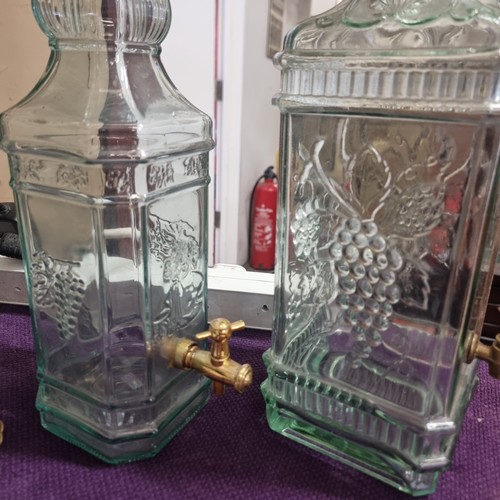 73 - 3 X LARGE ORNATE GLASS  BOTTLE DECANTERS WIH GRAPE MOULDING DECORATION  2 WITH BRASS TAP DISPENSERS,... 