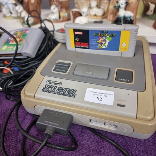 82 - NINTENDO , SUPER NINTENDO ENTERTAINMENT SYSTEM, MODEL SNPS-001A (UK V). COMES WITH SUPER MARIOWORLD ... 