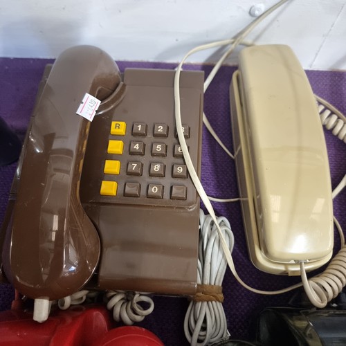 119 - 4 VINTAGE TELEPHONES IN VARIOUS COLOURS.