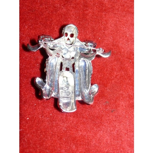 11 - BUTLER AND WILSON SKELETON BIKER BROOCH, BLACK AND RED ENAMEL DETAIL ADORNED IN CRYSTALS