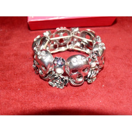 10 - BUTLER AND WILSON SILVER TONE 6 SKULL BANGLE WITH DIAMANTE AND FAUX PEARL DETAIL