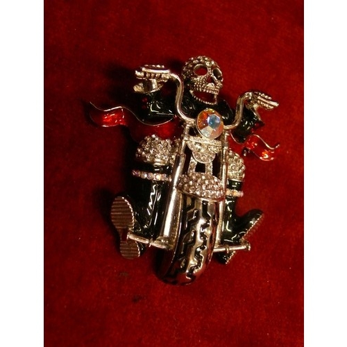 11 - BUTLER AND WILSON SKELETON BIKER BROOCH, BLACK AND RED ENAMEL DETAIL ADORNED IN CRYSTALS