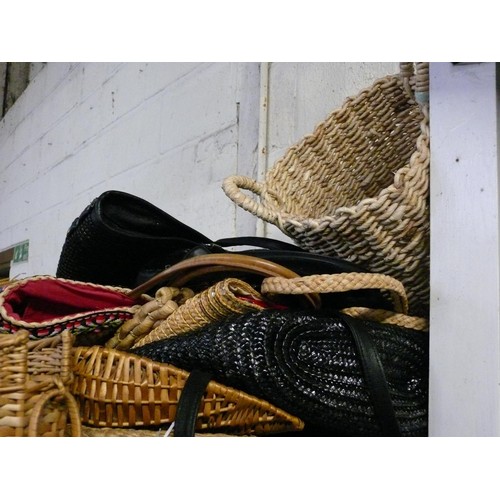 469 - A WHOLE SHELF OF WICKER BASKETS AND VARIOUS BAGS.