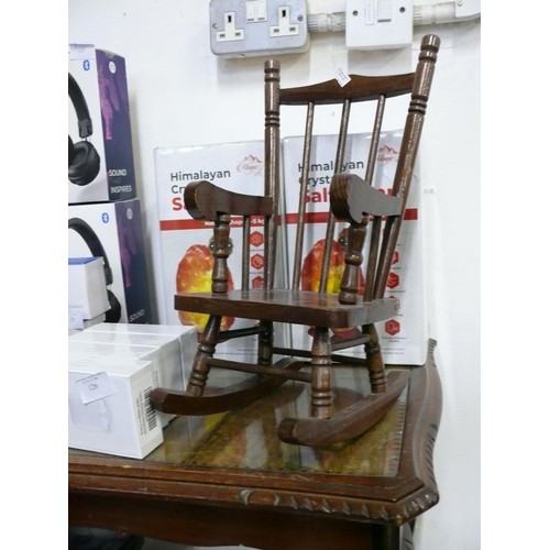 124 - A VINTAGE DOLLS ROCKING CHAIR