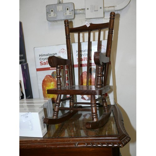 124 - A VINTAGE DOLLS ROCKING CHAIR