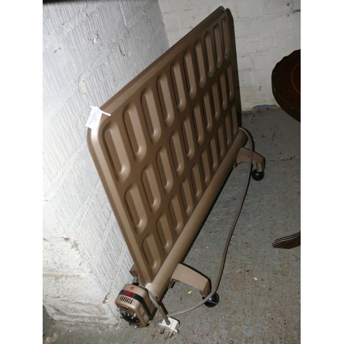A VINTAGE DIMPLEX OIL FILLED RADIATOR IN A GOLD FINISH, WITH PERIOD ...