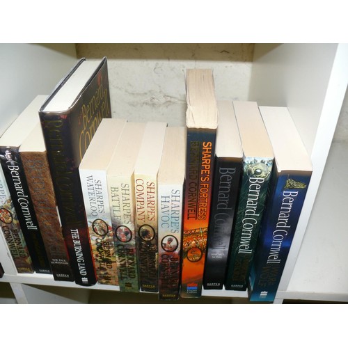 220 - A SET OF BOOKS BY BERNARD CORNWELL, MOSTLY PAPERBACKS