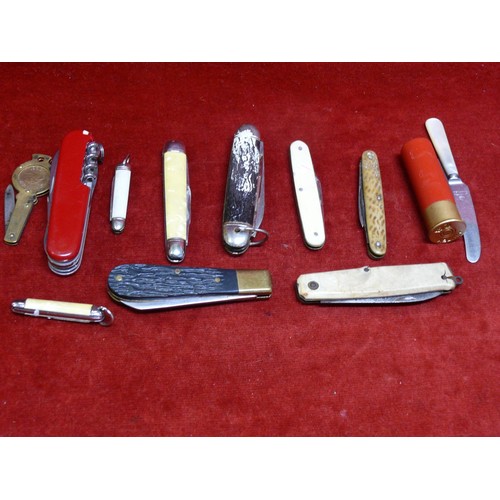 47 - A tin of folding penknives, including French Pradel cow horn, swiss army, mother of pearl and a  sho... 