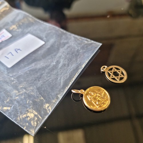 17A - 2 9ct GOLD PENDENTS A STAR OF DAVID AND ST CHRISTOPHER WEIGHT 1.6gr