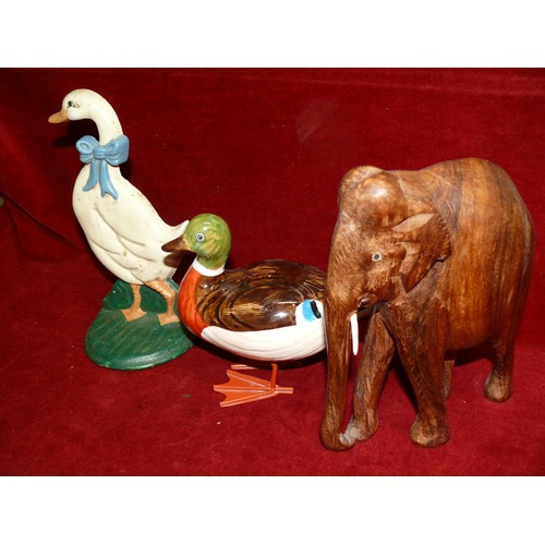 72 - A CARVED WOODEN ELEPHANT WITH BOTH HIS TUSKS! PLUS A CAST IRON GOOSE DOOR STOP AND A CERAMIC DUCK