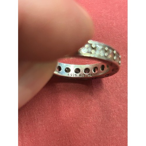 36 - 925 SILVER ETERNITY RING SET WITH CLEAR STONES THE SQUARE BAND ENGRAVED WITH LEAF DESIGN. SIZE M/N